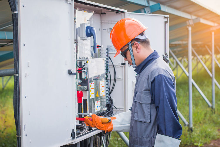 Manual worker examining machinery