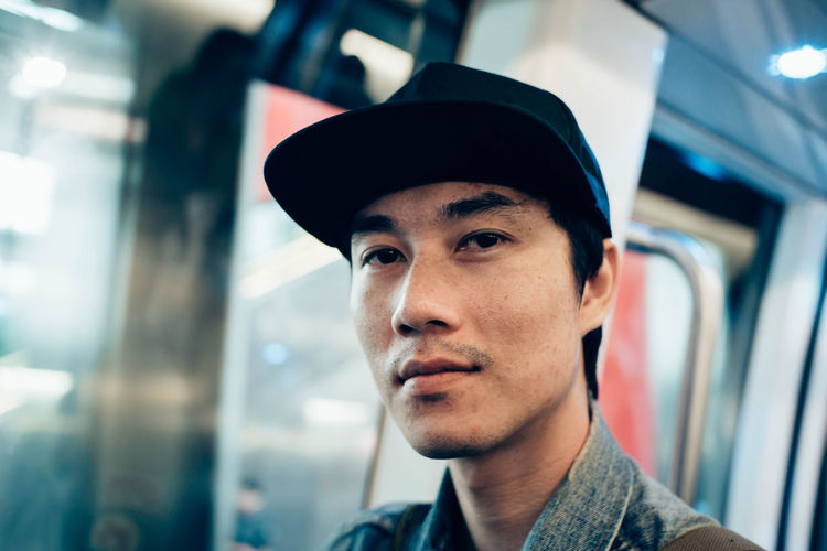 Portrait of young man in train