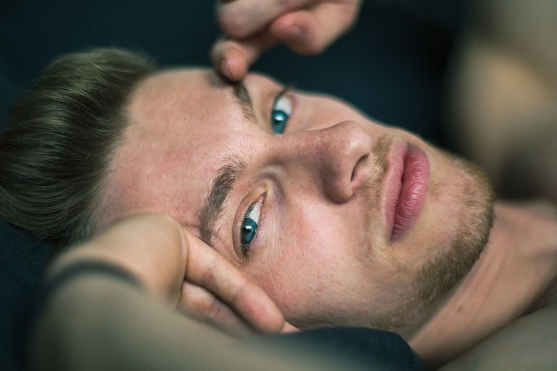 Close-up portrait of a man lying down