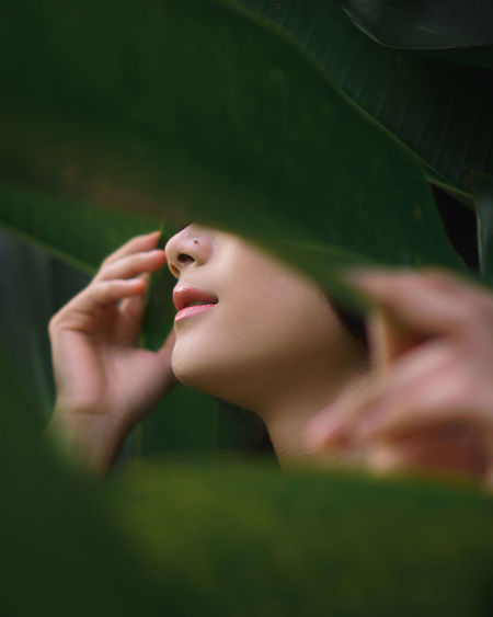 Close-up of woman hand on grass