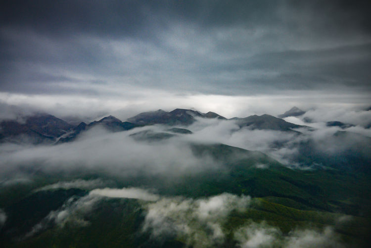 Scenic view of clouds over mountains