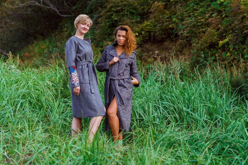 Portrait of fashionable women standing in grass