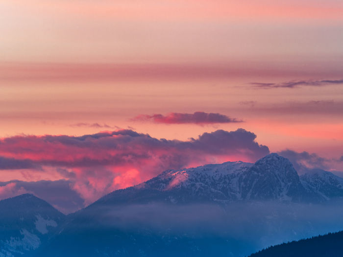 Scenic view of snowcapped mountains against sky during sunset