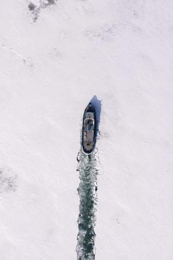 High angle view of umbrella on snow covered field