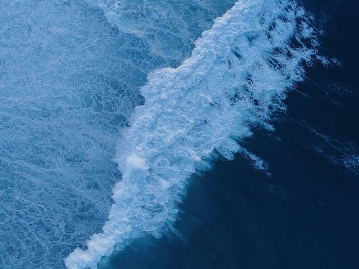 High angle view of waves splashing in sea