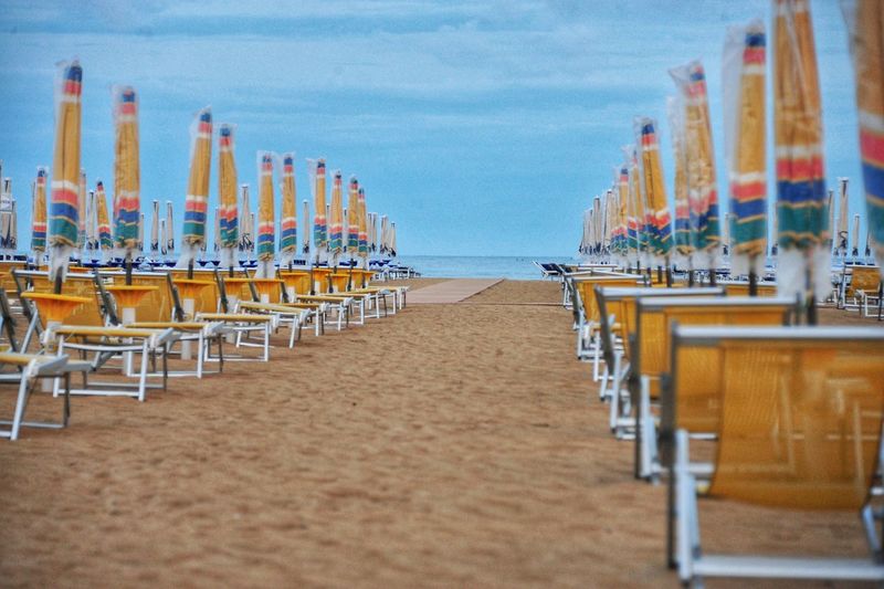 Panoramic shot of chairs on beach against sky