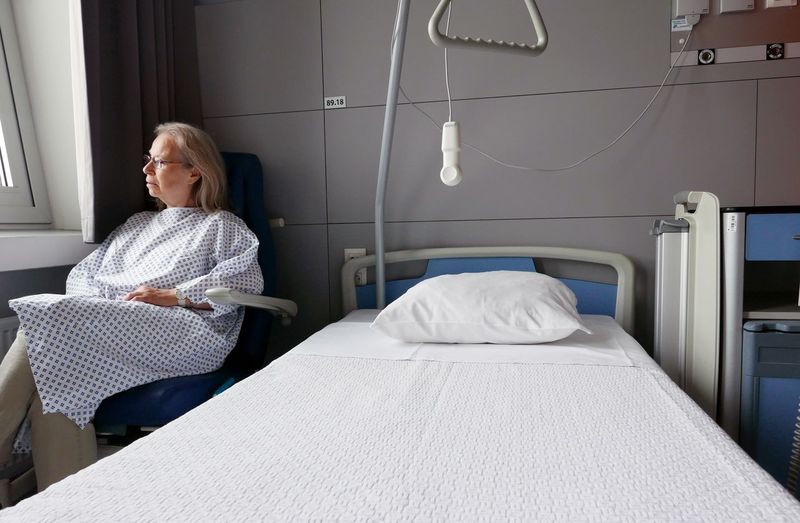 Senior patient sitting on chair in hospital