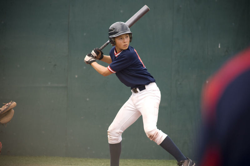 Young baseball player in batters box ready to swing