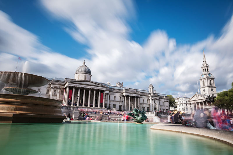 Tourists and locals gather at the main entrance to the national gallery in trafalgar square.