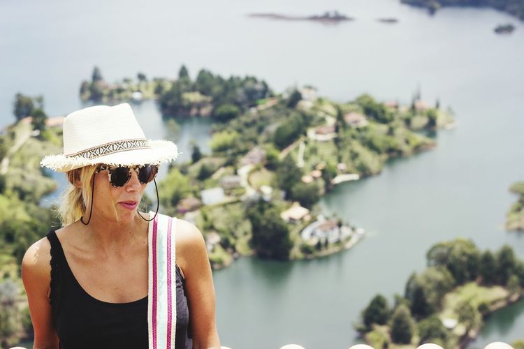 Woman wearing hat against lake