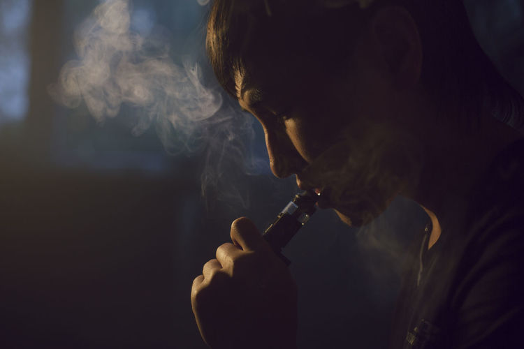 Rear view of man smoking cigarette