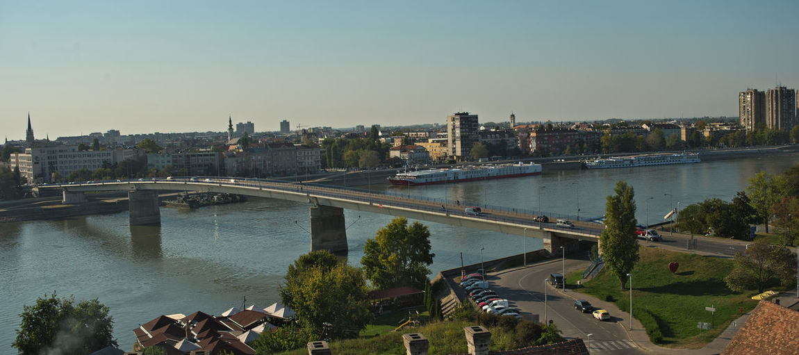 High angle view of bridge over river and buildings against sky