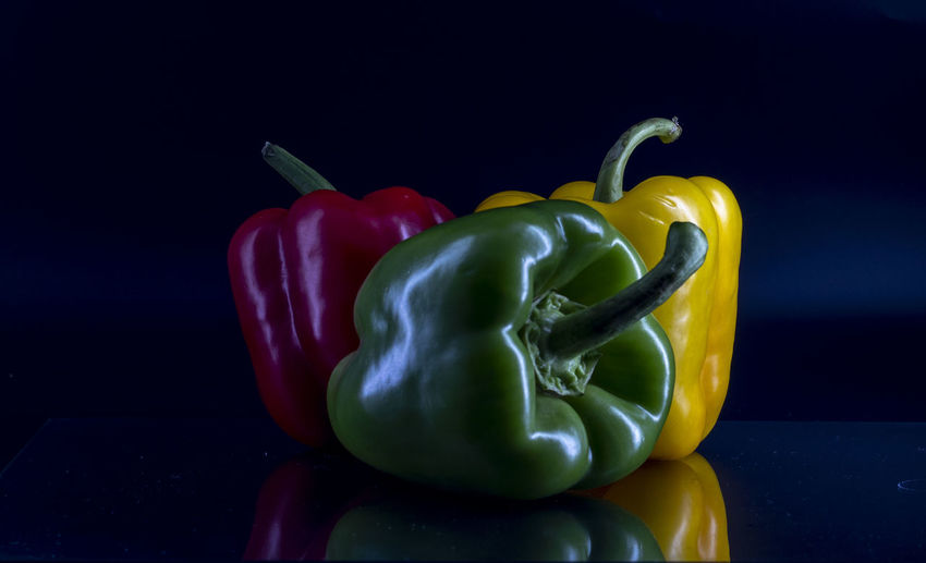 Close-up of bell peppers against black background