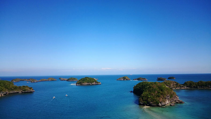 Long-range shot of hundred islands national park in the philippines on a clear summer day.