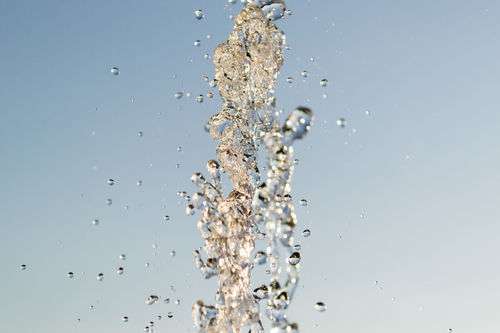 CLOSE-UP OF SPLASHING WATER AGAINST SKY