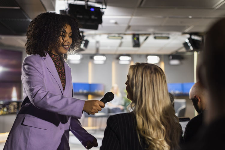 Tv show host interviewing audience member