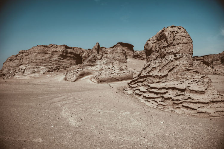 Rock formations in desert against clear sky