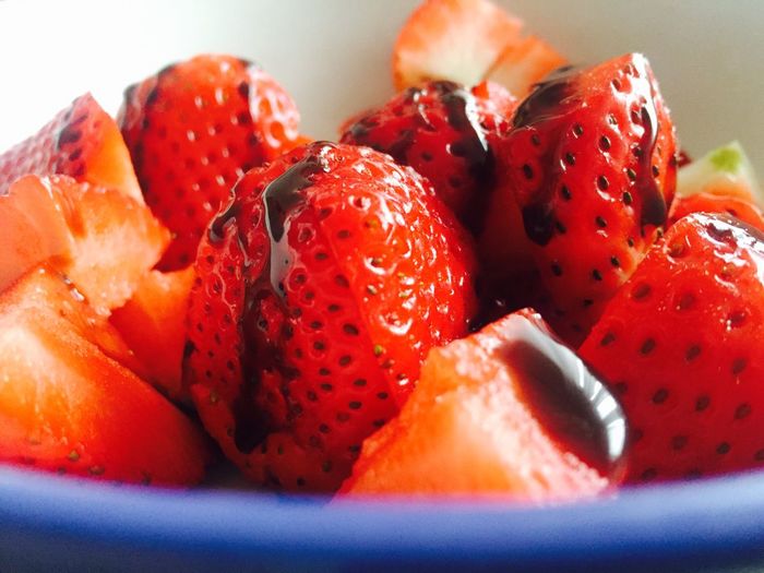 Close-up of chopped strawberries with chocolate sauce in bowl