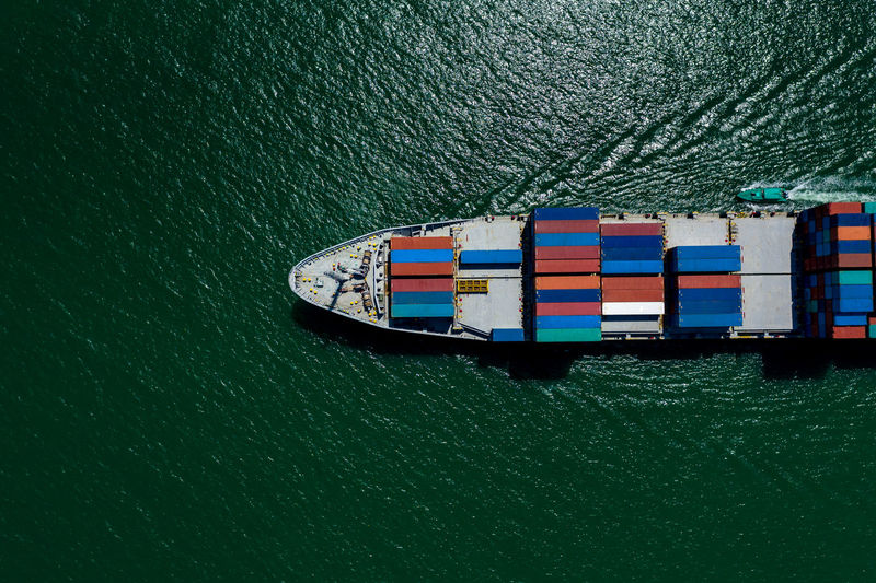 Containers ship import and export international businesses services by the sea aerial view 