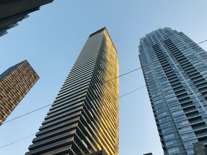 Low angle view of modern buildings against clear sky skyline highest
