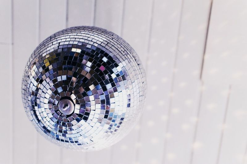 Low angle view of disco ball hanging from ceiling