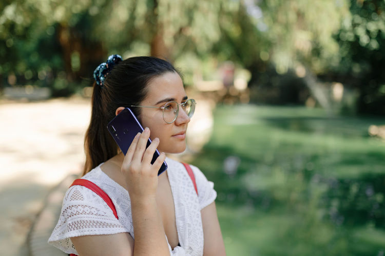 Young woman using mobile phone outdoors