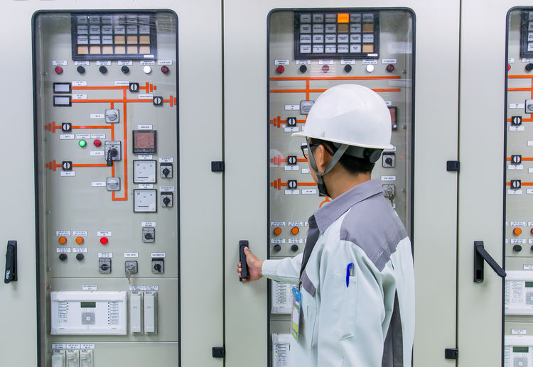 Engineer opening door of electric meter