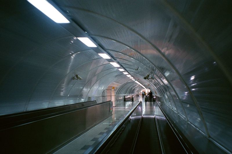 Moving walkway in illuminated modern subway station