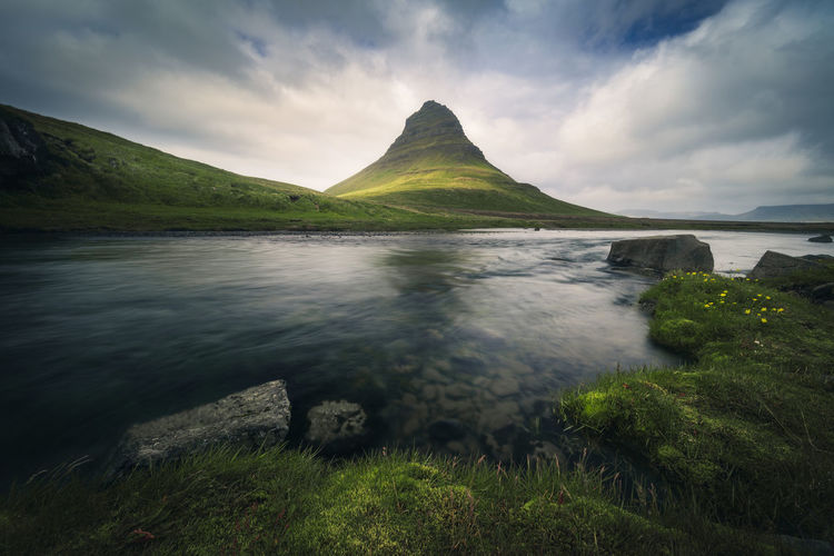 Low-angle view of kirkjufell mountain against dramatic cloudy sky, iceland, snaefellsnes peninsula