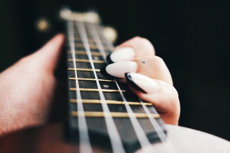 Close-up of hand holding guitar