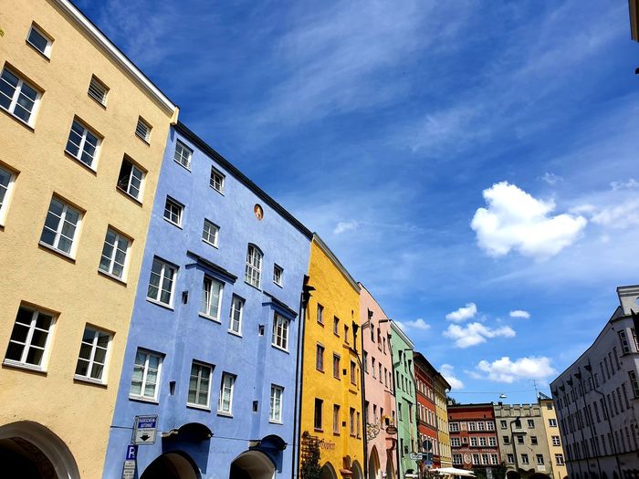 Low angle view of colourful buildings in town against sky