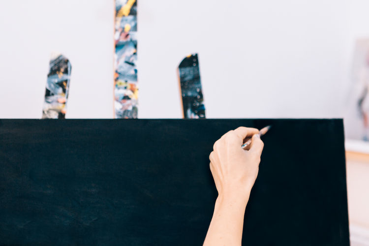 Close-up of hand drawing on blackboard