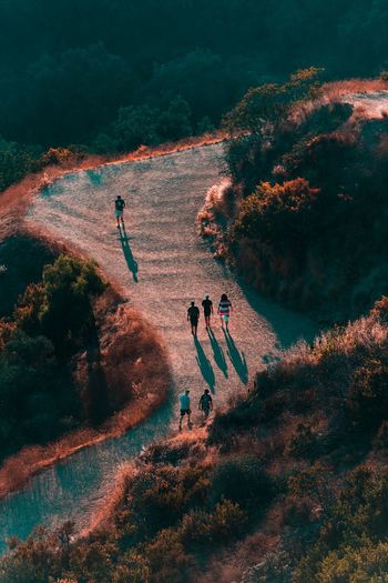 High angle view of people walking on mountain road