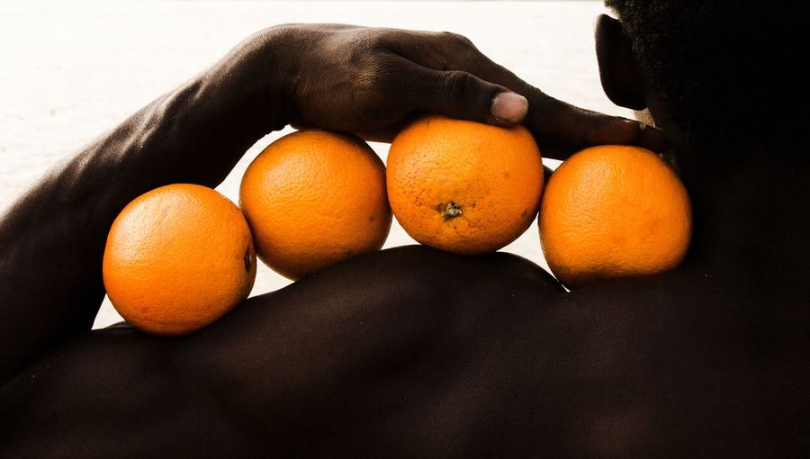 HIGH ANGLE VIEW OF ORANGES ON ORANGE TABLE
