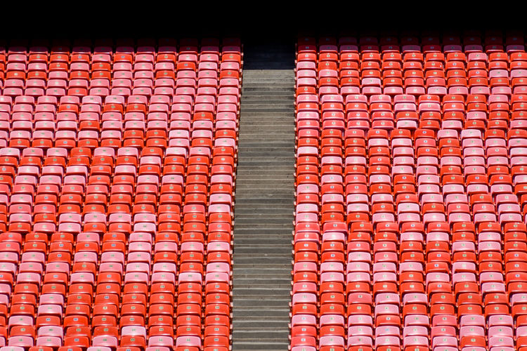 Full frame shot red seats in empty sports stadium
