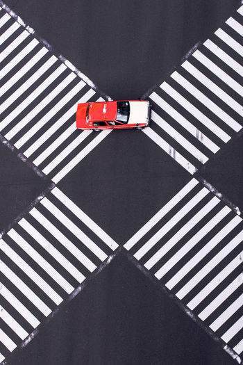 High angle view of car on intersecting pedestrian crossings