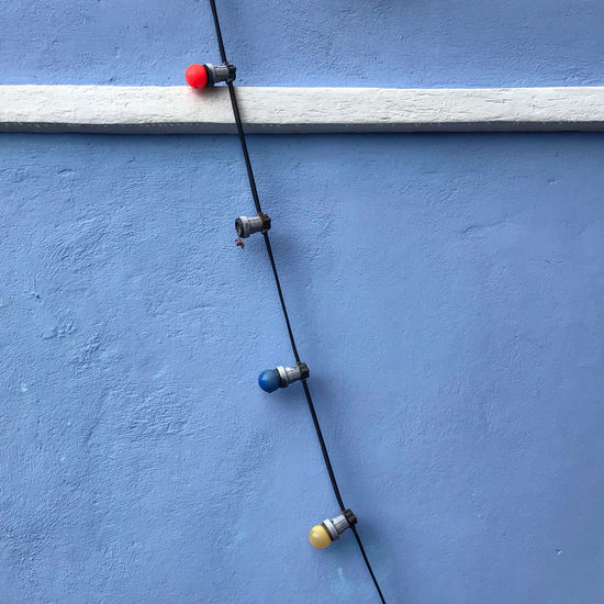 Close-up of light bulbs hanging on wall