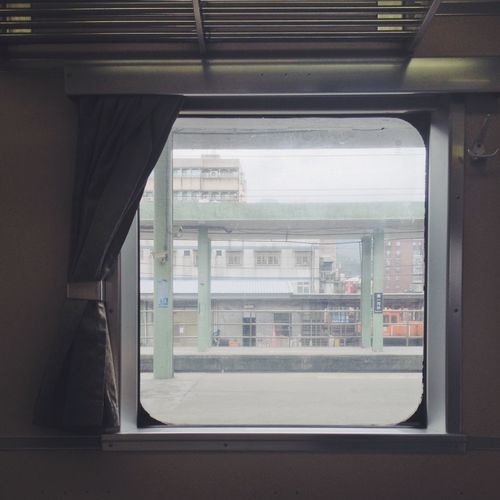 Railroad station platforms seen through train window