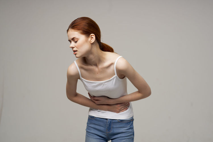 Young woman suffering from stomach ache
