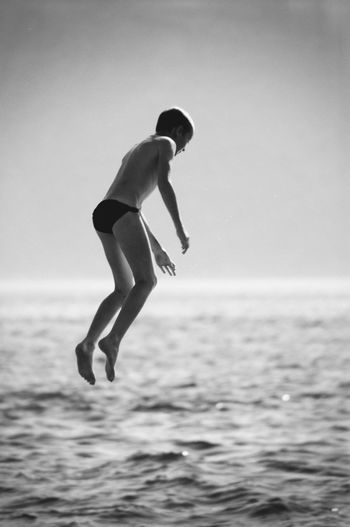 Full length of boy jumping on beach