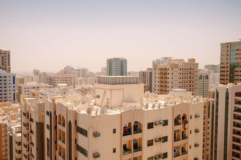 High angle view of city buildings against clear sky