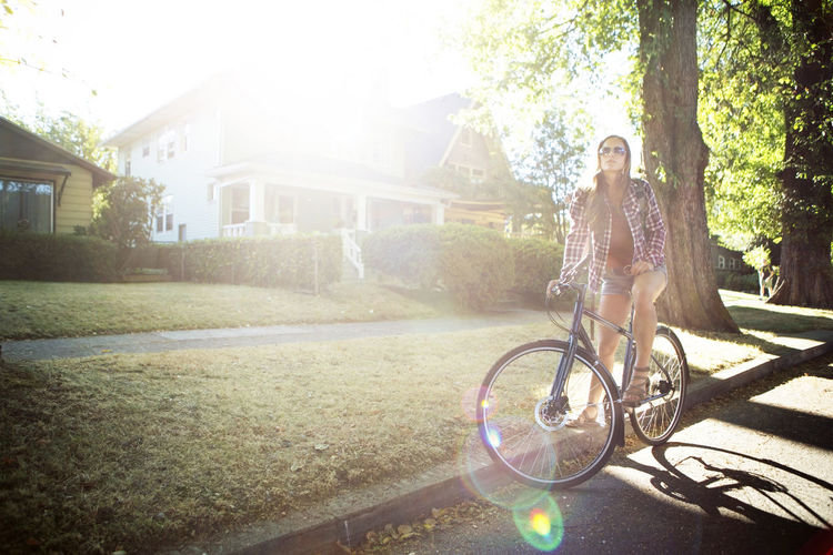 Young woman with bicycle on street