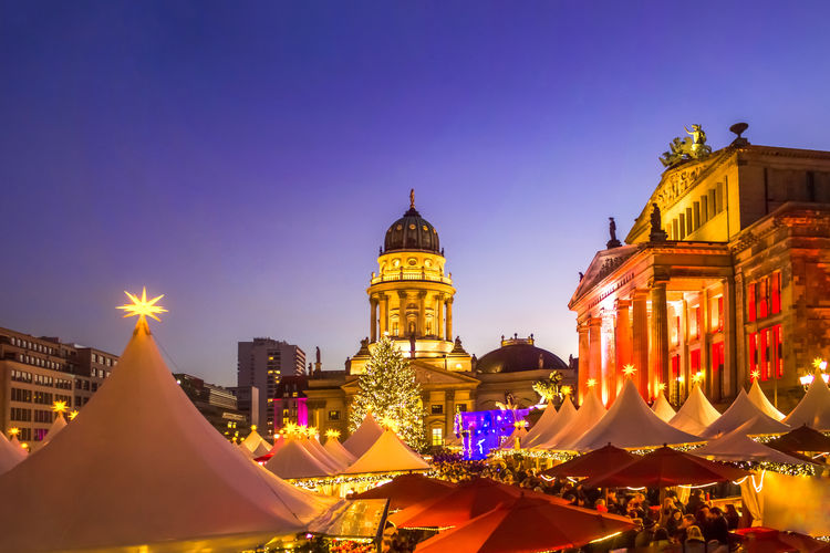 Tents outside neue kirche against sky in city during christmas