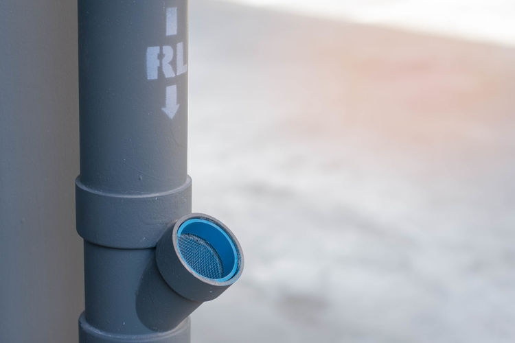 Close-up of coin-operated binoculars against blue sky
