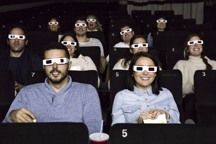 People with 3d glasses watching a movie in a cinema