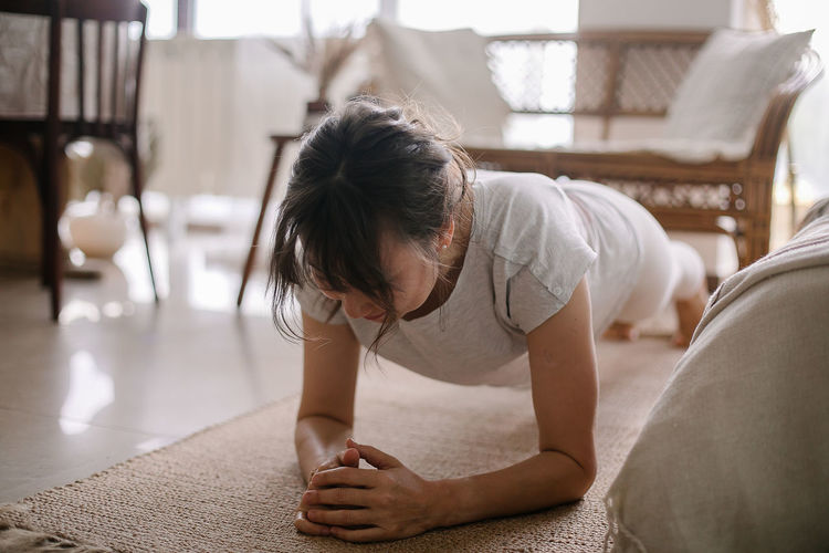 Woman doing plank exercise at home