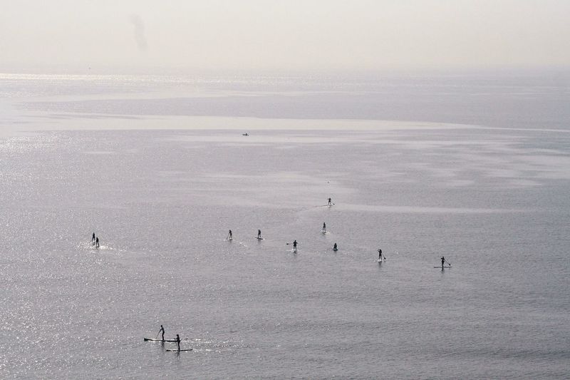 People paddling in sea