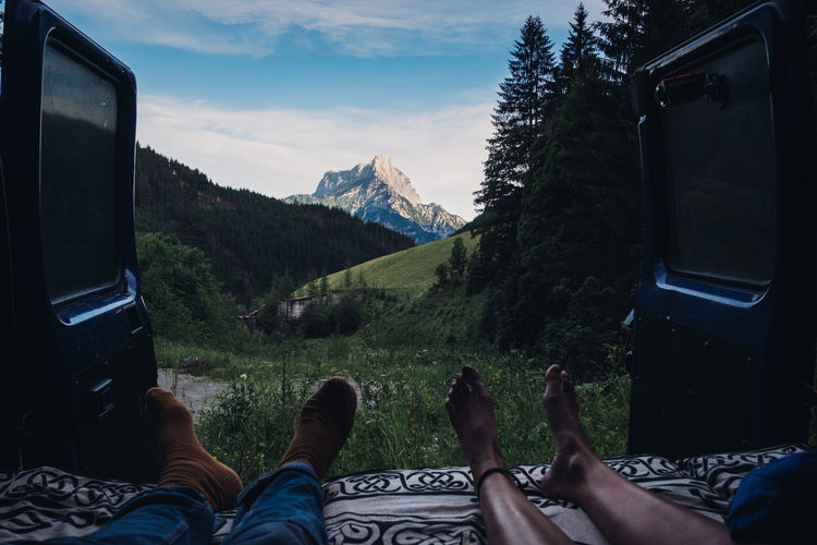 Low section of people relaxing in camper van