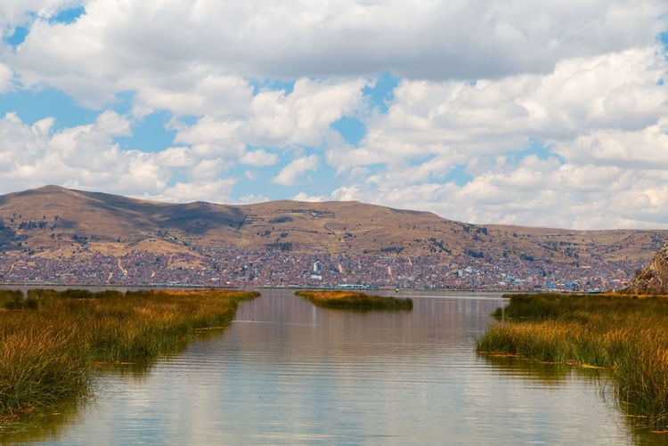 Scenic view of lake and mountains against sky