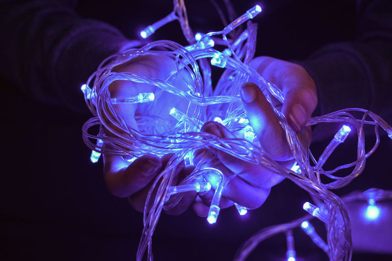 Close-up of woman hand with illuminated lights